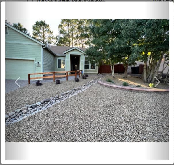 Landscaped yard with gravel, decorative rocks, and plants near a home.