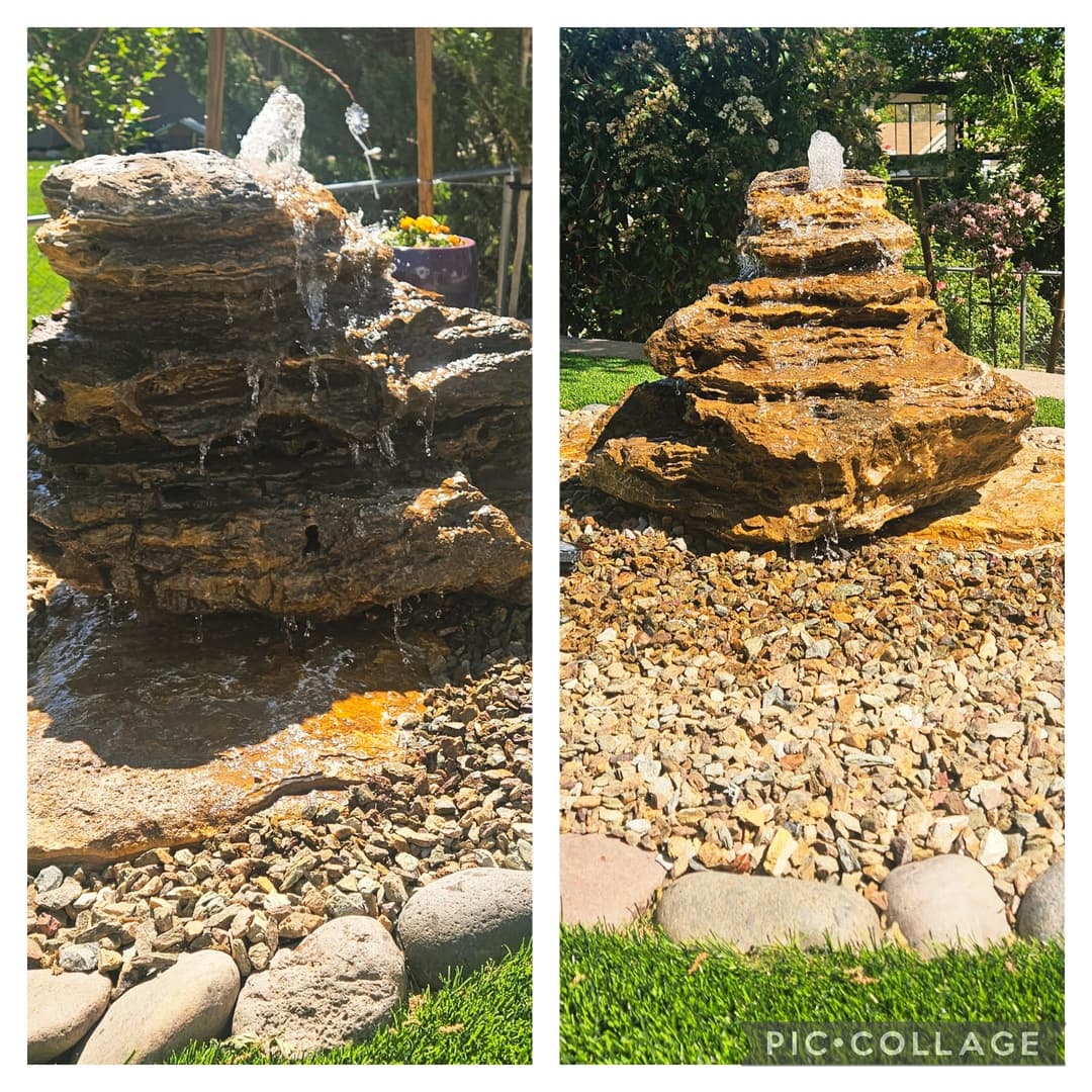 Water fountain with cascading water over natural stone, surrounded by decorative gravel and plants.